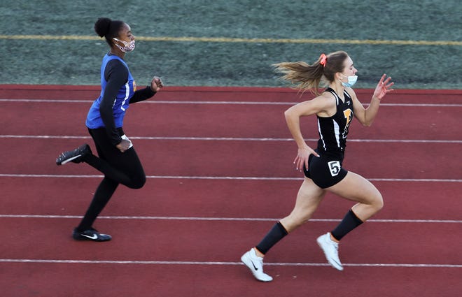 Padua's Juliana Balon (right) comes out of the turn with a lead over third-place finisher Tatiana Kelsic before Balon won the 200 meter dash during the DIAA state indoor track and field championships at Dover High School Wednesday, March 3, 2021.