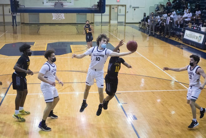 Salesianum's Justin Molen (10) reaches out for a rebound in front of Tatnall's Omari Banks (10) during their DIAA Boys Basketball Tournament quarterfinal game Tuesday, March 9, 2021. Salesianum defeated Tatnall 61-47.