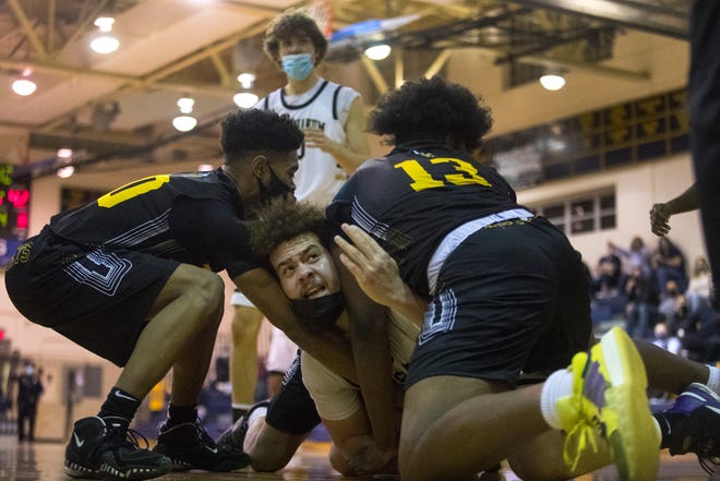 Salesianum's Jackson Conkey (42) looks to the referee while guarding the ball from Tatnall's Devyn Benson (13) and Omari Banks (10) during their DIAA Boys Basketball Tournament quarterfinal game Tuesday, March 9, 2021. Salesianum defeated Tatnall 61-47.